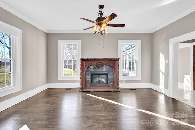 unfurnished living room featuring ceiling fan, dark wood-type flooring, crown molding, and a fireplace