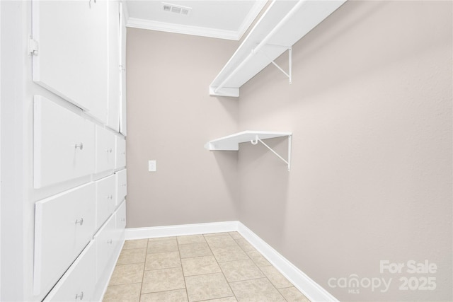 spacious closet with light tile patterned floors