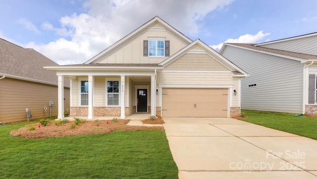 craftsman-style house featuring covered porch and a front yard