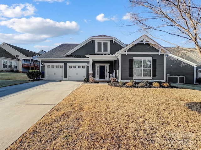 craftsman-style house featuring a front yard and a garage