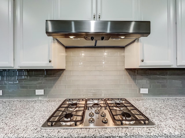 kitchen with range hood and white cabinetry