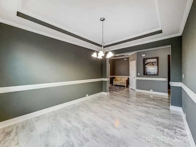 unfurnished dining area with a chandelier, ornamental molding, and a raised ceiling