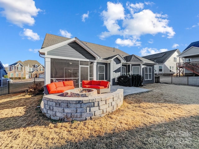 back of house with a sunroom, an outdoor fire pit, and a patio