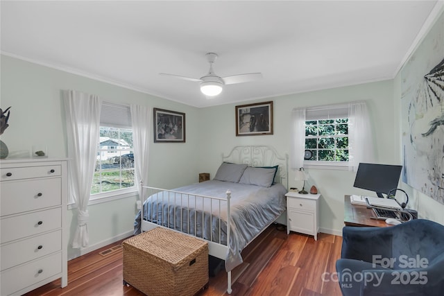 bedroom featuring ceiling fan, dark hardwood / wood-style flooring, and ornamental molding