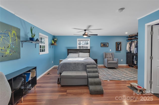 bedroom featuring dark wood-type flooring, ceiling fan, and a closet