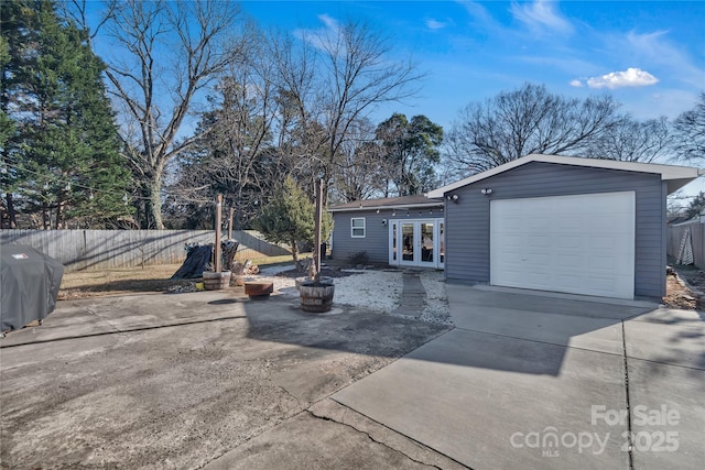 back of property featuring french doors and a garage