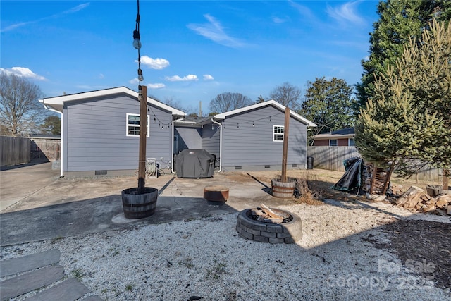 rear view of house featuring a fire pit