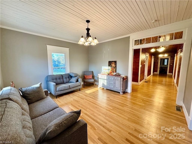 living room featuring ornamental molding, light wood-type flooring, a notable chandelier, and wood ceiling