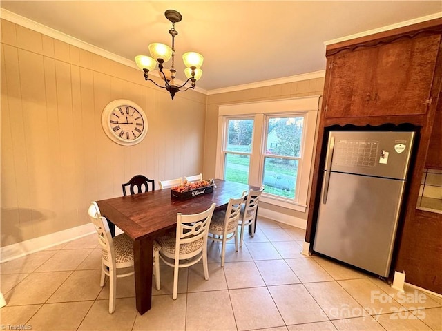 tiled dining room featuring crown molding and an inviting chandelier