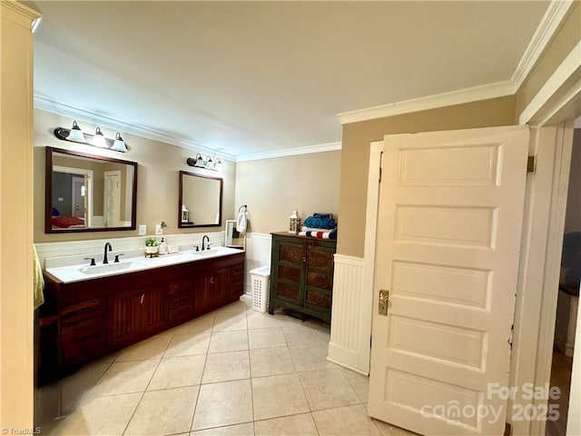 bathroom with vanity, ornamental molding, and tile patterned flooring