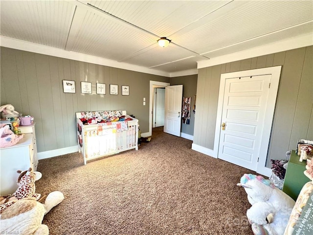 bedroom with wood walls and carpet flooring