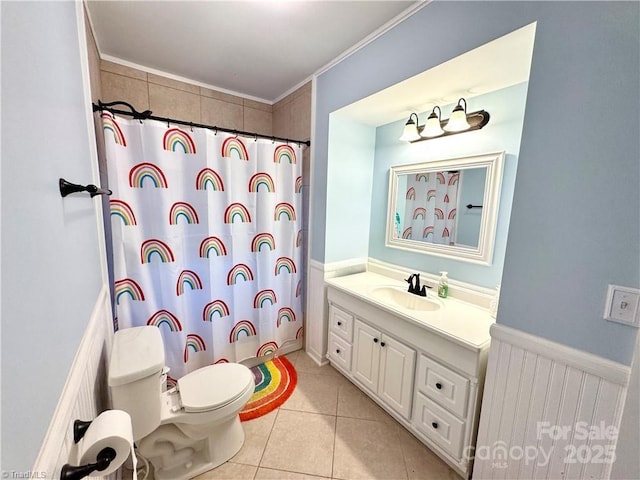 bathroom featuring tile patterned flooring, vanity, toilet, ornamental molding, and a shower with shower curtain