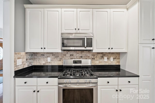 kitchen featuring stainless steel appliances, decorative backsplash, and white cabinets