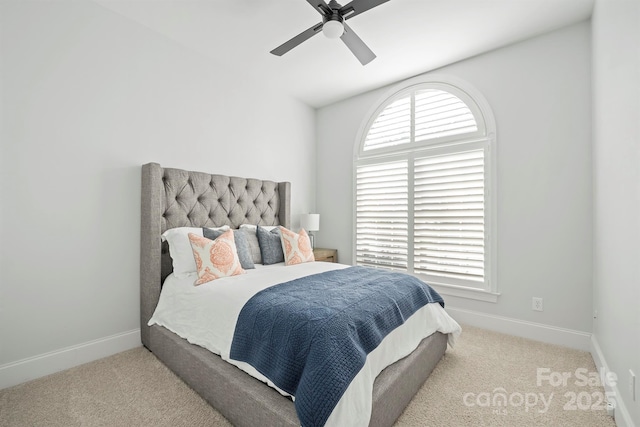 bedroom with ceiling fan and light colored carpet