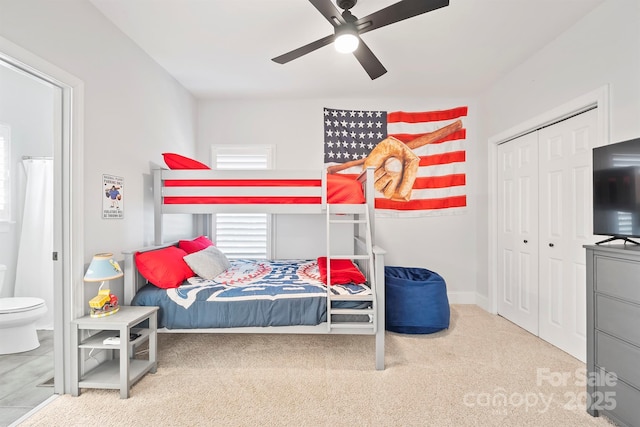 carpeted bedroom with ceiling fan, a closet, and connected bathroom