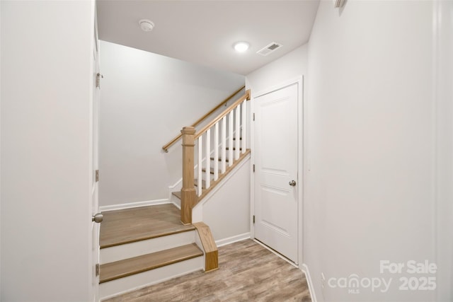 staircase featuring hardwood / wood-style flooring