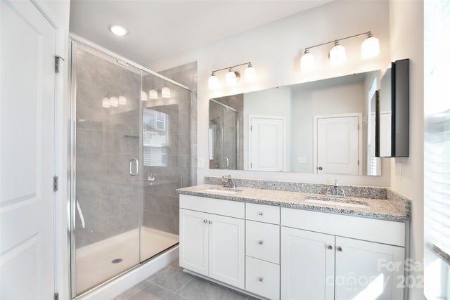 bathroom featuring vanity, tile patterned floors, and a shower with shower door