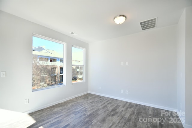 empty room featuring dark wood-type flooring