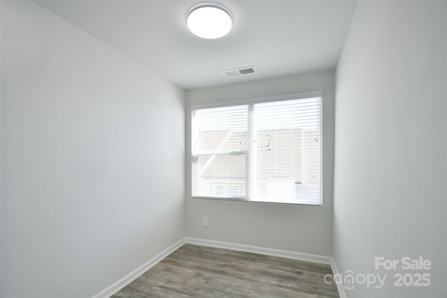 spare room featuring dark wood-type flooring