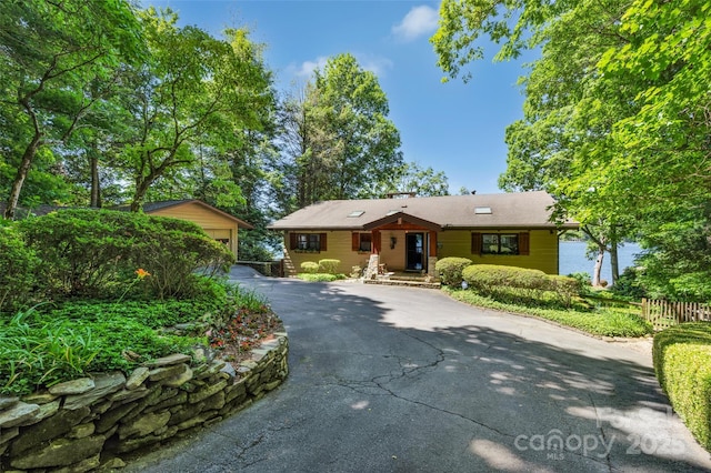 single story home with a garage and an outdoor structure