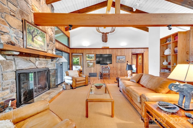 living room with a fireplace, high vaulted ceiling, beam ceiling, and wood walls