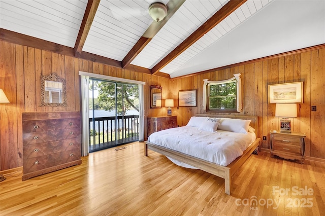 bedroom with light wood-type flooring, access to exterior, high vaulted ceiling, and wood walls