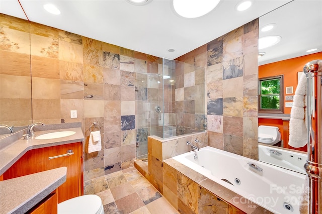 full bathroom with vanity, toilet, shower with separate bathtub, and tile walls