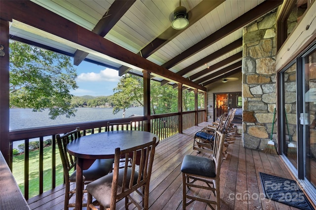 sunroom featuring a water view and lofted ceiling with beams