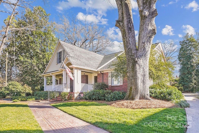 view of front property with a porch and a front lawn