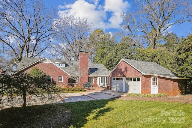 view of front of property featuring a garage and a front lawn