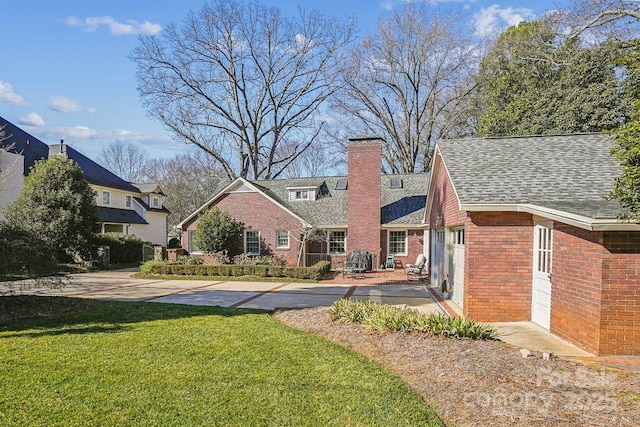 back of house featuring a patio and a yard