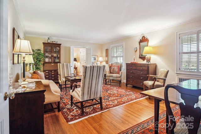 living room featuring hardwood / wood-style floors and crown molding