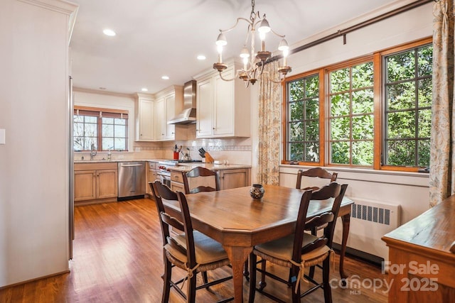 dining area featuring a wealth of natural light, radiator, and crown molding