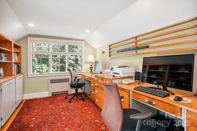 home office featuring radiator and vaulted ceiling