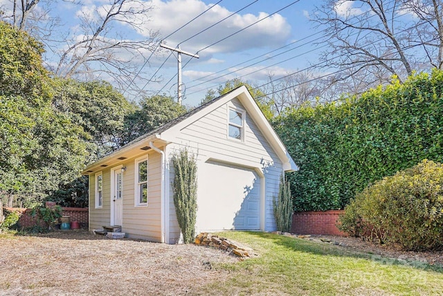 view of home's exterior featuring a lawn, an outbuilding, and a garage