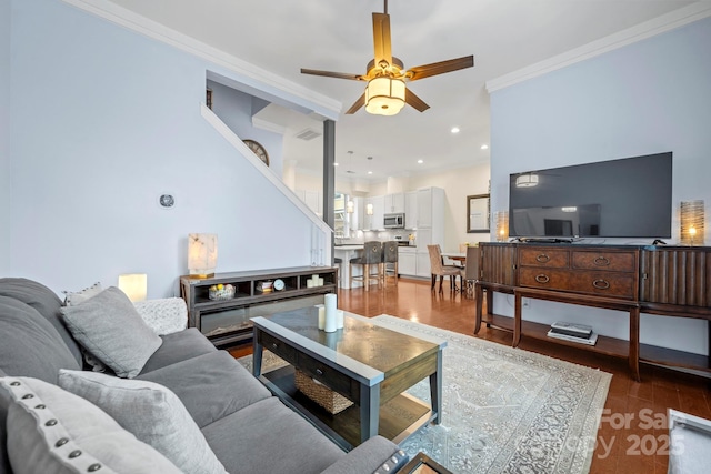 living room with ceiling fan, dark hardwood / wood-style floors, and ornamental molding