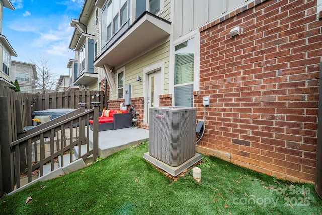 exterior space with central AC unit, an outdoor living space, and a patio