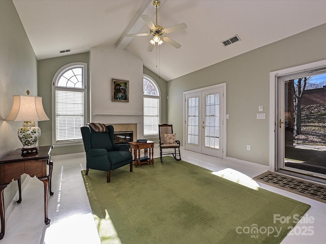 living area featuring carpet floors, vaulted ceiling with beams, ceiling fan, and french doors