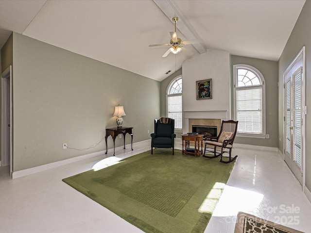 sitting room with ceiling fan and vaulted ceiling with beams