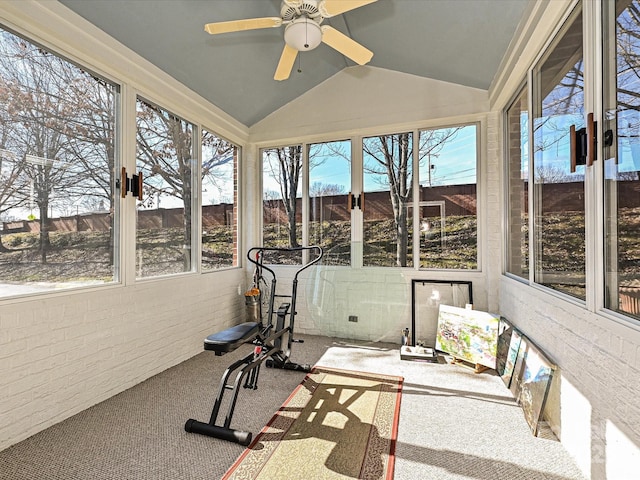 sunroom with ceiling fan, a wealth of natural light, and lofted ceiling