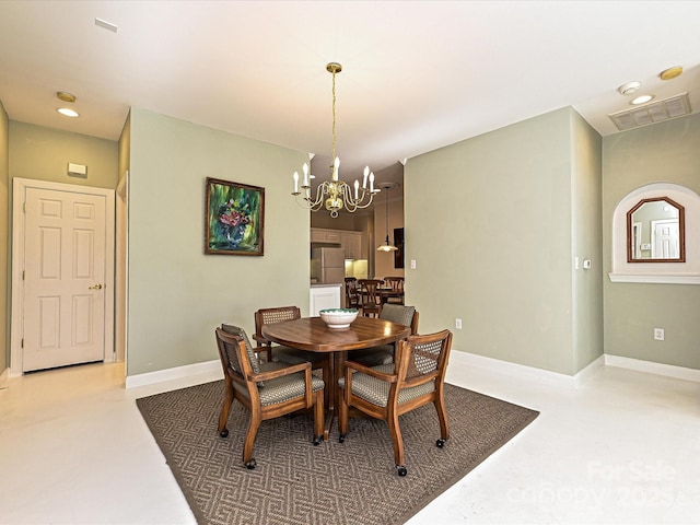 dining space with concrete floors and a notable chandelier