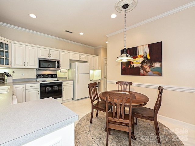 kitchen featuring decorative light fixtures, white fridge, electric range, white cabinetry, and ornamental molding