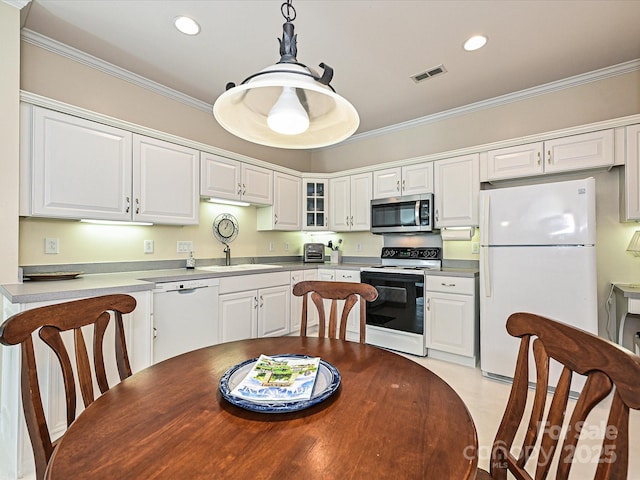 kitchen featuring white cabinetry, white appliances, pendant lighting, crown molding, and sink