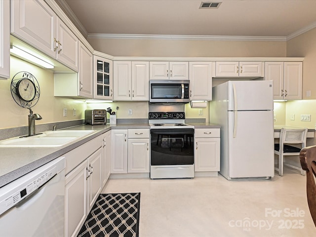 kitchen with sink, white appliances, white cabinetry, and ornamental molding