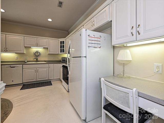 kitchen featuring ornamental molding, sink, white cabinets, and white appliances