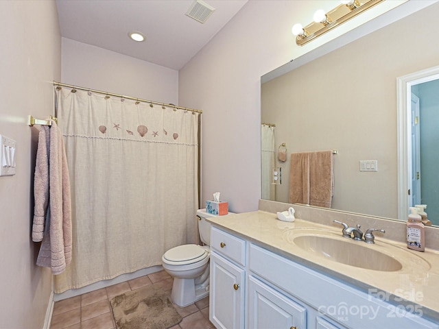 bathroom with toilet, tile patterned floors, and vanity