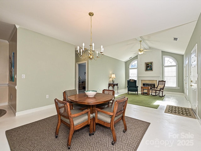 dining area with ceiling fan with notable chandelier, concrete floors, lofted ceiling with beams, and a tiled fireplace