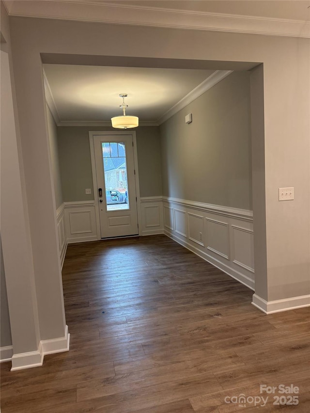 entrance foyer featuring dark hardwood / wood-style flooring and ornamental molding