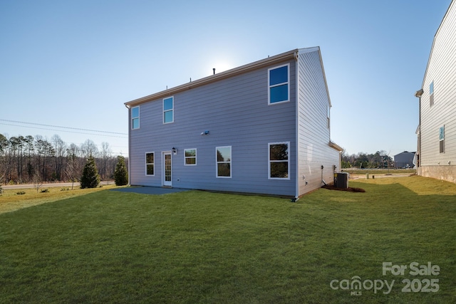 rear view of house featuring cooling unit and a yard