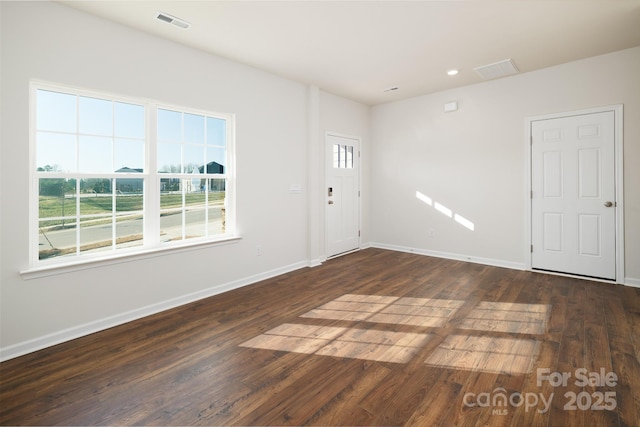 unfurnished room featuring dark hardwood / wood-style flooring